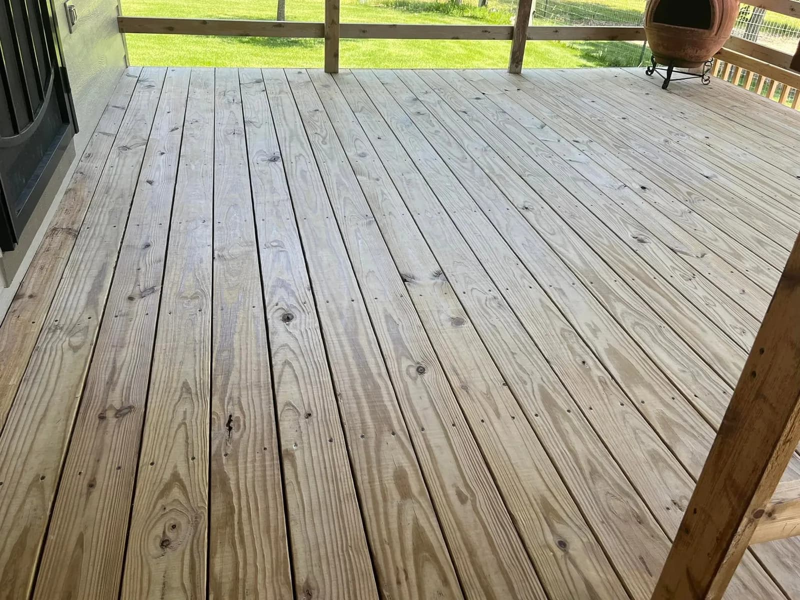 A Wichita deck after cleaning and staining, the boards an even honey tone